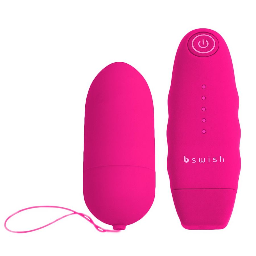 Telecomando rosa classico B SWISH Unleashed, con pulsanti e design elegante, visibile in primo piano nell'immagine.