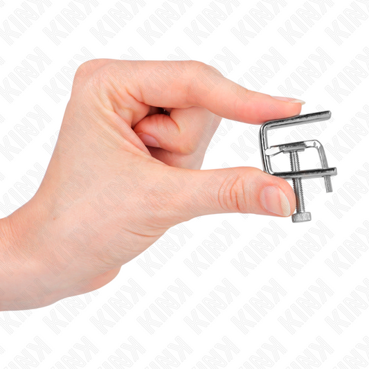 Morse per capezzoli KINK NIPPLE GRIP, accessorio in metallo con pulegge, usato per giochi BDSM e stimolazione sensoriale.
