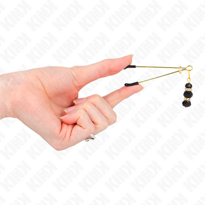 Pinze per capezzoli KINK NIPPLE GRIP con finitura dorata e 3 perline di vetro nere, lunghezza 7 cm, visibile sull'immagine.