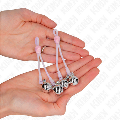 Pinze per capezzoli KINK Teschio luminoso con anello campanelli regolabile rosa e argento, design audace e luminoso.